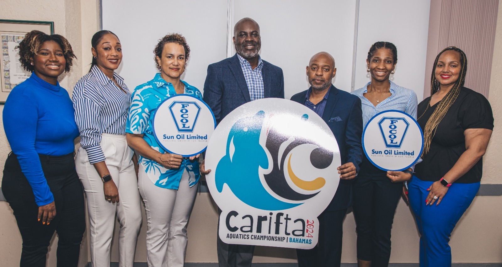 Clinton Rolle, Managing Director and General Manager, FOCOL Sun Oil and Fabian Fernander, Sun Oil Sales and Marketing Manager are pictured with members of the CARIFTA Aquatics 2024 Marketing Team.
